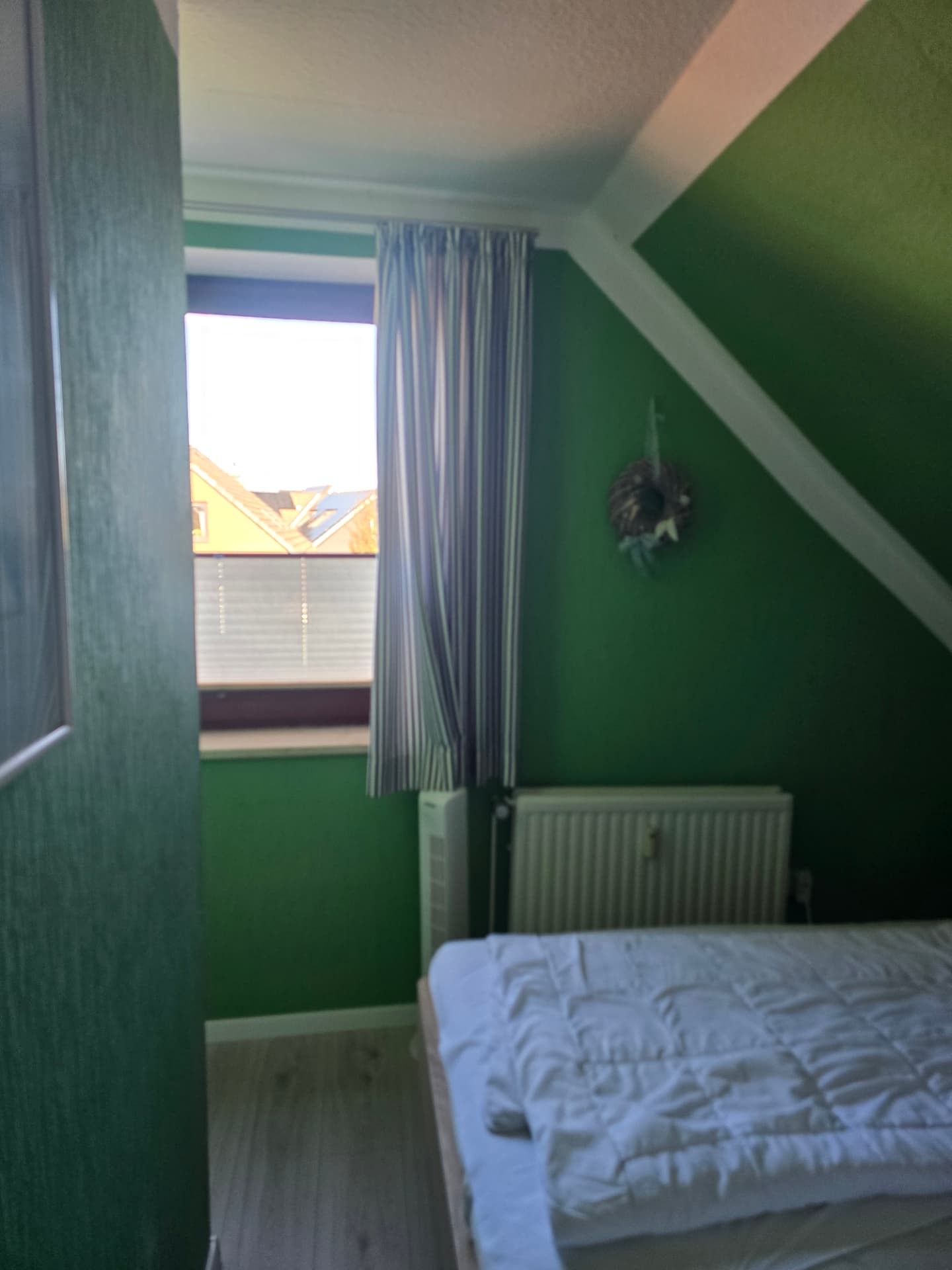 Schlafzimmer mit Doppelbett und weißem Kleiderschrank in der Muscheln Wohnung